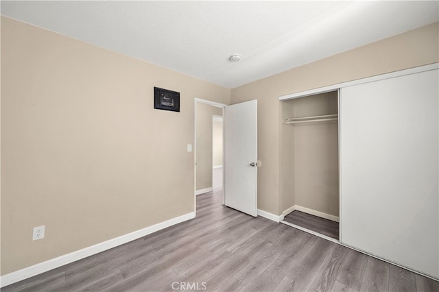 4137 Tiberon Dr, Oceanside, CA 92056 - unfurnished bedroom with wood finished floors, a closet, and baseboards