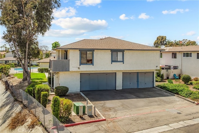 4137 Tiberon Dr, Oceanside, CA 92056 - view of front of house featuring a garage, stucco siding, driveway, and a shingled roof