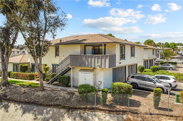 4137 Tiberon Dr, Oceanside, CA 92056 - view of property with stucco siding, stairway, an attached garage, driveway, and a residential view