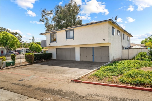 4137 Tiberon Dr, Oceanside, CA 92056 - multi unit property with an attached garage, stucco siding, and driveway