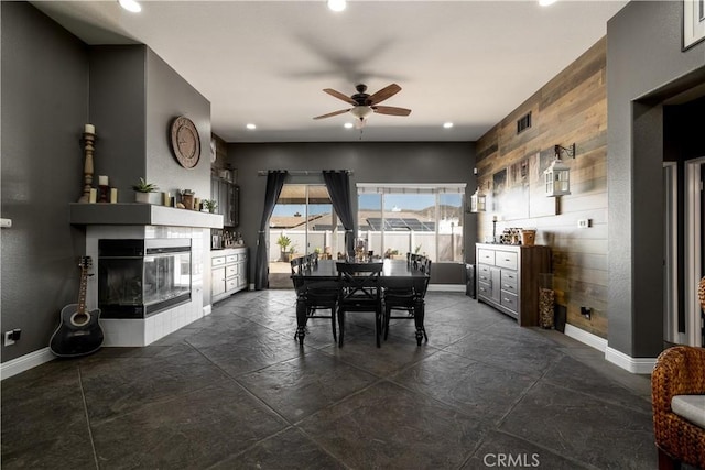 13946 Moqui Way, Corona, CA 92883 - dining space with a ceiling fan, baseboards, a multi sided fireplace, and recessed lighting