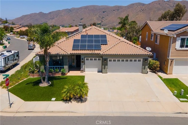 13946 Moqui Way, Corona, CA 92883 - view of front of home featuring a tile roof, a mountain view, solar panels, a front yard, and concrete driveway
