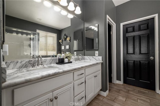 13946 Moqui Way, Corona, CA 92883 - full bathroom with double vanity, wood finished floors, a shower with shower door, and baseboards