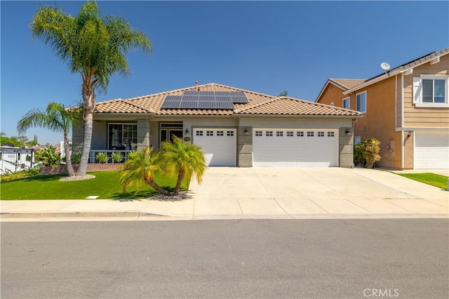 13946 Moqui Way, Corona, CA 92883 - view of front of house with a tiled roof, a garage, roof mounted solar panels, and concrete driveway