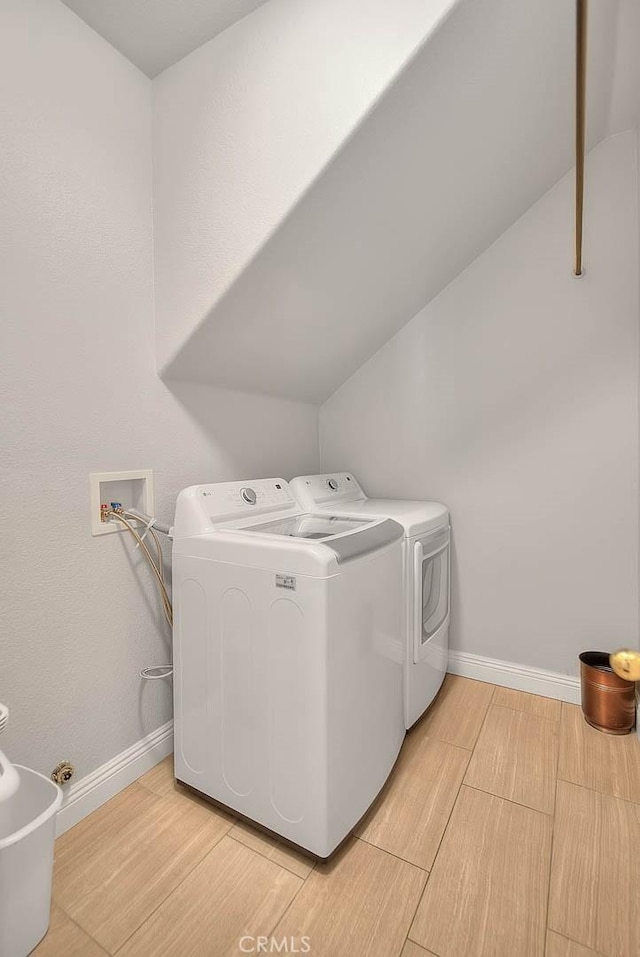 8758 Aspen Ct, Riverside, CA 92508 - laundry area with separate washer and dryer, wood tiled floors, and baseboards