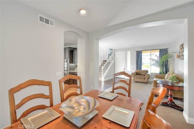 8758 Aspen Ct, Riverside, CA 92508 - dining area with arched walkways, stairs, and baseboards