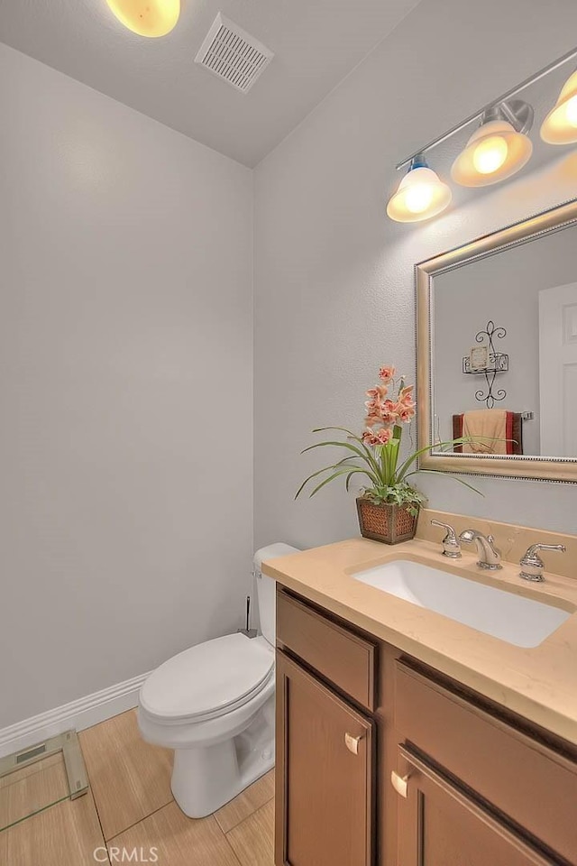 8758 Aspen Ct, Riverside, CA 92508 - half bath featuring vanity, toilet, tile patterned floors, and baseboards