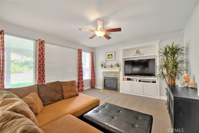 8758 Aspen Ct, Riverside, CA 92508 - living area featuring ceiling fan, baseboards, a fireplace, built in features, and light carpet