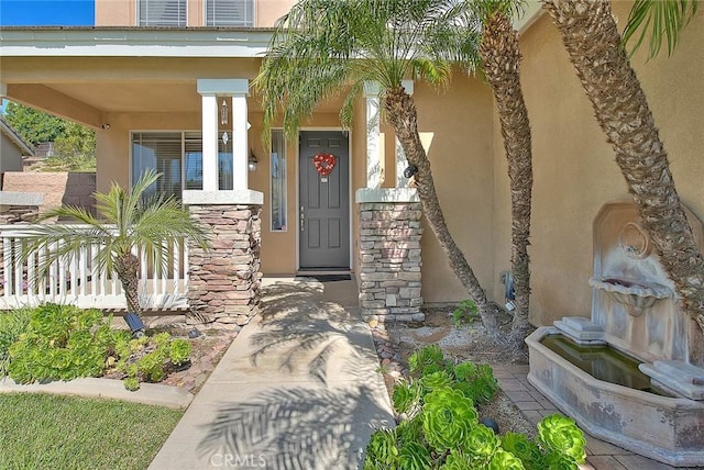 8758 Aspen Ct, Riverside, CA 92508 - property entrance featuring stucco siding, a porch, and stone siding