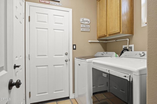 1269 Hacienda Dr, Oxnard, CA 93030 - washroom with cabinet space, separate washer and dryer, and dark tile patterned floors