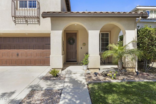 1269 Hacienda Dr, Oxnard, CA 93030 - entrance to property with stucco siding, an attached garage, driveway, and a tile roof