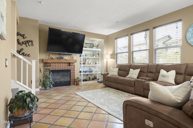 1269 Hacienda Dr, Oxnard, CA 93030 - living room featuring tile patterned floors, stairway, a tile fireplace, and built in features