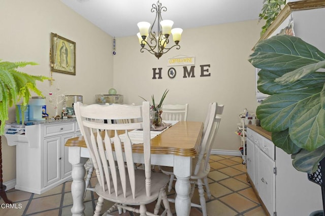 1269 Hacienda Dr, Oxnard, CA 93030 - dining room featuring a chandelier, light tile patterned flooring, and baseboards