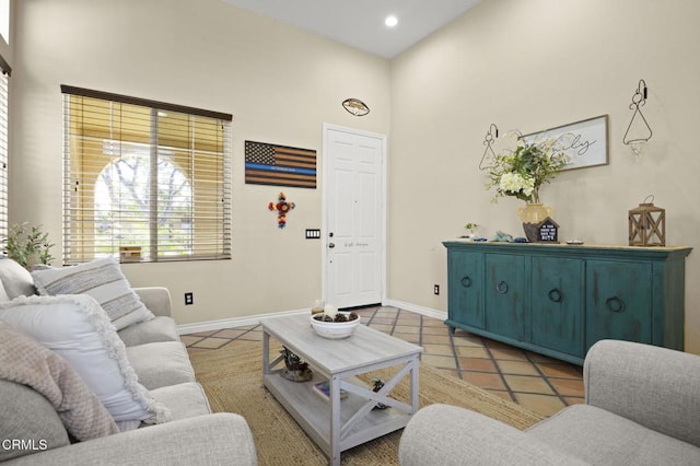 1269 Hacienda Dr, Oxnard, CA 93030 - living area with a high ceiling, baseboards, tile patterned flooring, and recessed lighting