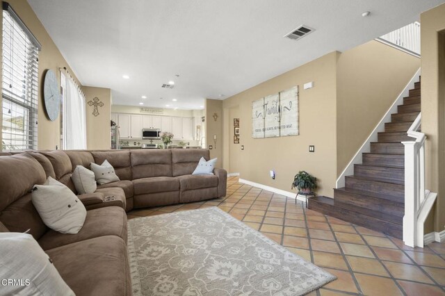 1269 Hacienda Dr, Oxnard, CA 93030 - living room with light tile patterned floors, baseboards, stairs, plenty of natural light, and recessed lighting