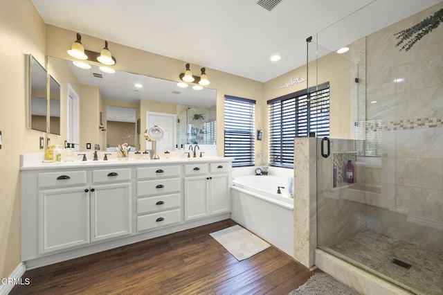 1269 Hacienda Dr, Oxnard, CA 93030 - full bathroom featuring a garden tub, wood finished floors, double vanity, and a shower stall
