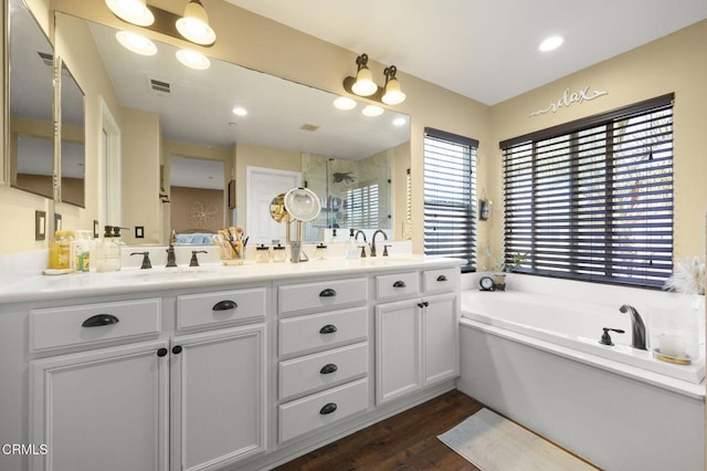 1269 Hacienda Dr, Oxnard, CA 93030 - bathroom featuring double vanity, a shower stall, a bath, and wood finished floors