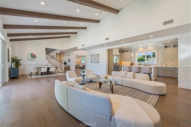 20701 Dumont St, Woodland Hills, CA 91364 - living area featuring hardwood / wood-style flooring, a decorative wall, recessed lighting, wainscoting, and stairway