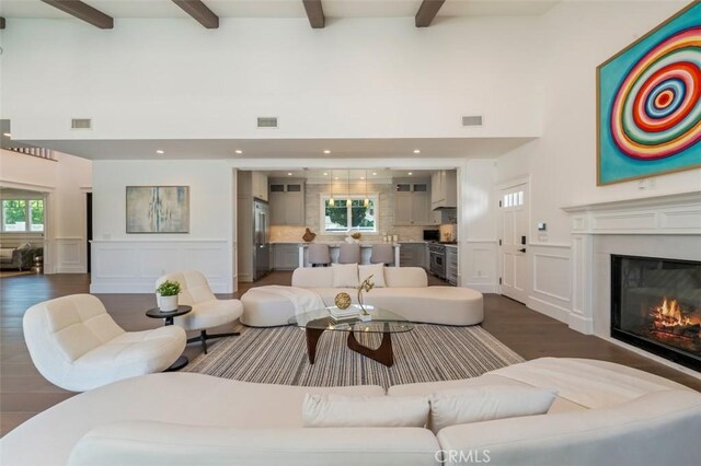 20701 Dumont St, Woodland Hills, CA 91364 - living area with a decorative wall, beamed ceiling, dark wood finished floors, a glass covered fireplace, and a wainscoted wall