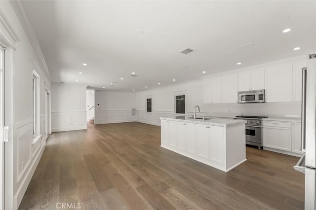 20701 Dumont St, Woodland Hills, CA 91364 - kitchen featuring appliances with stainless steel finishes, ornamental molding, a decorative wall, white cabinetry, and recessed lighting