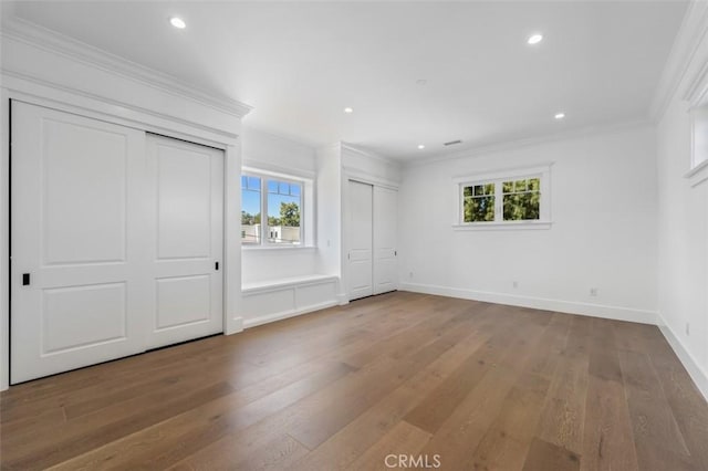 20701 Dumont St, Woodland Hills, CA 91364 - unfurnished bedroom featuring two closets, multiple windows, wood finished floors, crown molding, and recessed lighting