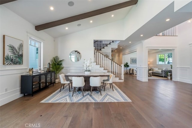 20701 Dumont St, Woodland Hills, CA 91364 - dining area featuring a decorative wall, stairs, beamed ceiling, wood finished floors, and high vaulted ceiling