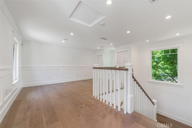 20701 Dumont St, Woodland Hills, CA 91364 - corridor featuring an upstairs landing, attic access, light wood-style floors, recessed lighting, and a wainscoted wall