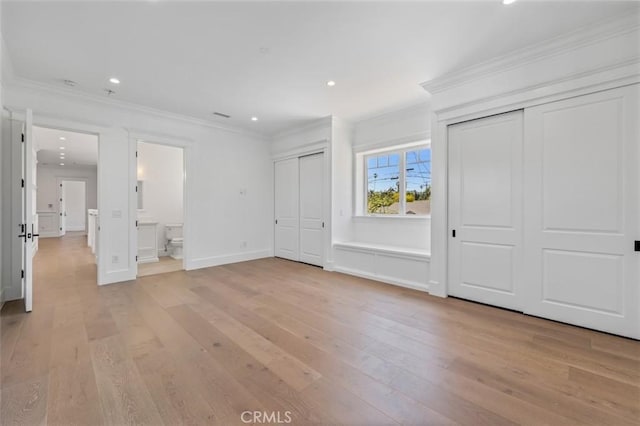 20701 Dumont St, Woodland Hills, CA 91364 - unfurnished bedroom with multiple closets, light wood-style flooring, recessed lighting, crown molding, and baseboards