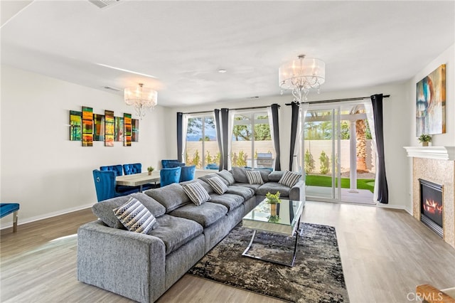 84020 Colibri Ct, Indio, CA 92203 - living area featuring a chandelier, wood finished floors, baseboards, and a tiled fireplace