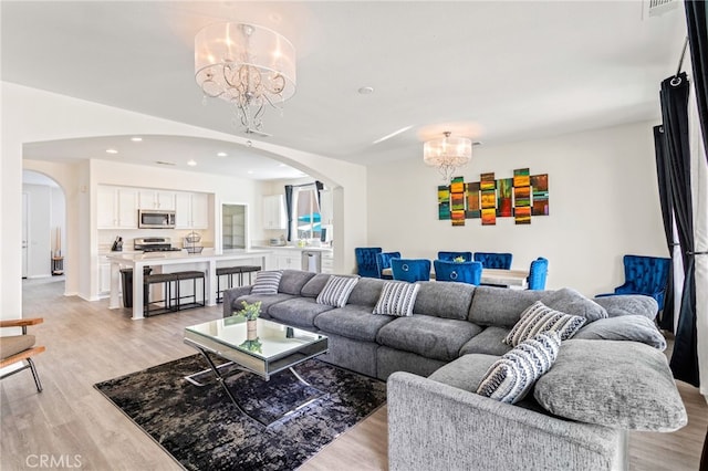 84020 Colibri Ct, Indio, CA 92203 - living area featuring a chandelier, arched walkways, light wood-style flooring, and recessed lighting