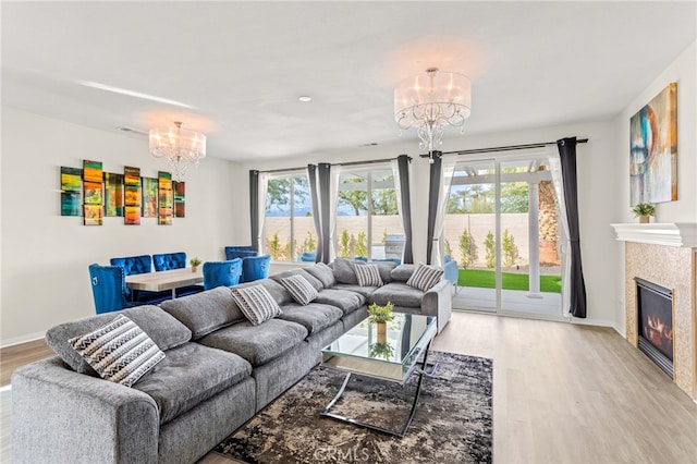84020 Colibri Ct, Indio, CA 92203 - living area featuring a chandelier, light wood-type flooring, baseboards, and a tiled fireplace