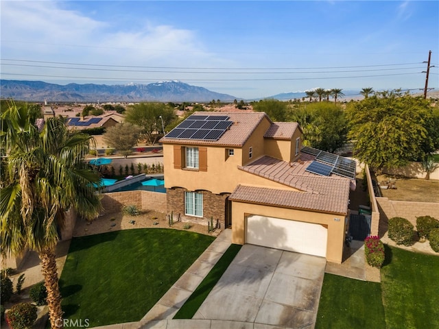 84020 Colibri Ct, Indio, CA 92203 - view of front of house featuring stucco siding, a tiled roof, roof mounted solar panels, a garage, and concrete driveway