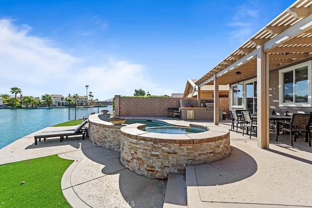 84250 Tramonto Way, Indio, CA 92203 - view of patio featuring an outdoor kitchen, a pergola, a water view, and a pool with connected hot tub