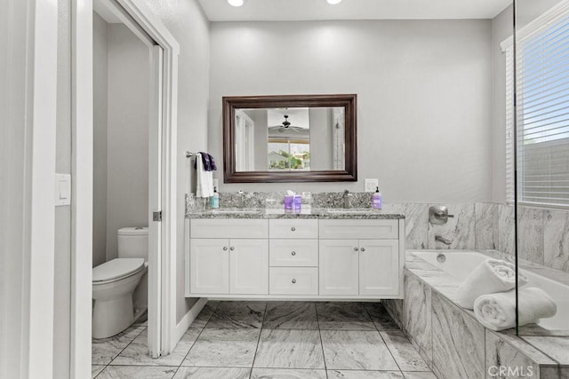 84250 Tramonto Way, Indio, CA 92203 - bathroom featuring marble look tiles, toilet, double vanity, a garden tub, and recessed lighting