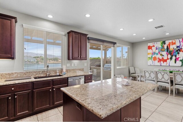 84250 Tramonto Way, Indio, CA 92203 - kitchen with a sink, recessed lighting, dishwasher, light stone counters, and a kitchen island