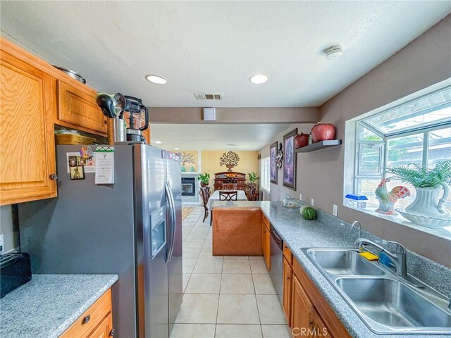 45431 Sancroft Ave, Lancaster, CA 93535 - kitchen with a sink, stainless steel appliances, light tile patterned floors, recessed lighting, and light countertops