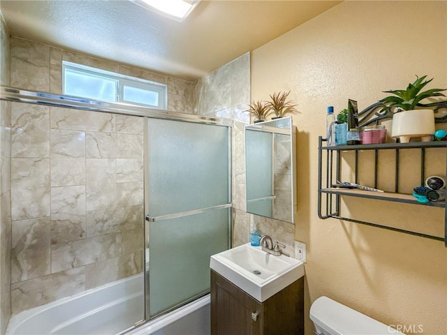 45431 Sancroft Ave, Lancaster, CA 93535 - full bathroom with toilet, enclosed tub / shower combo, vanity, and a textured wall