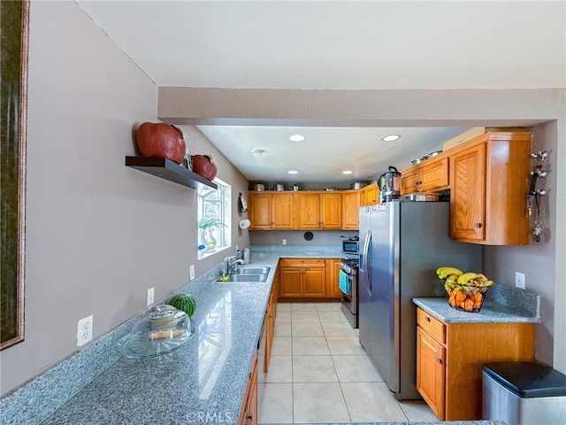 45431 Sancroft Ave, Lancaster, CA 93535 - kitchen with a sink, stainless steel appliances, brown cabinetry, recessed lighting, and light tile patterned flooring