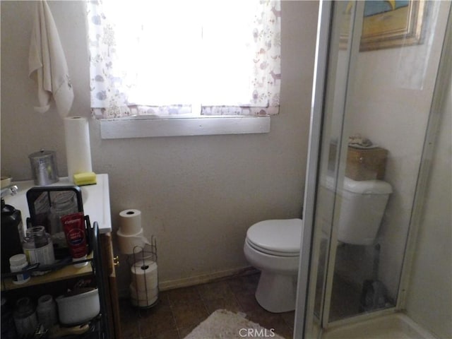 12861 Lakeview Dr, Clearlake Oaks, CA 95423 - bathroom featuring a shower stall, toilet, and tile patterned floors