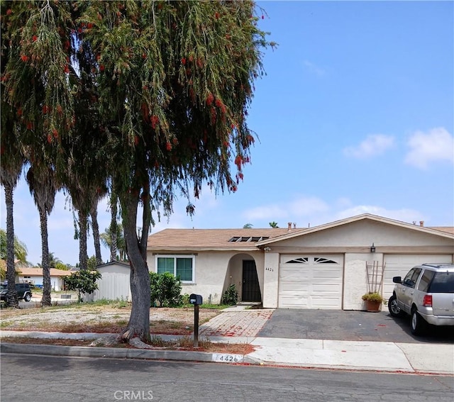 4426 Avenida Del Gado, Oceanside, CA 92057 - ranch-style home featuring a garage, stucco siding, and driveway