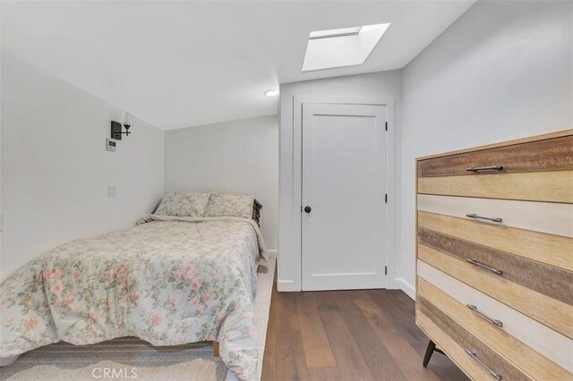 306 Avenida Monterey, San Clemente, CA 92672 - bedroom featuring a skylight, dark wood-style flooring, and baseboards