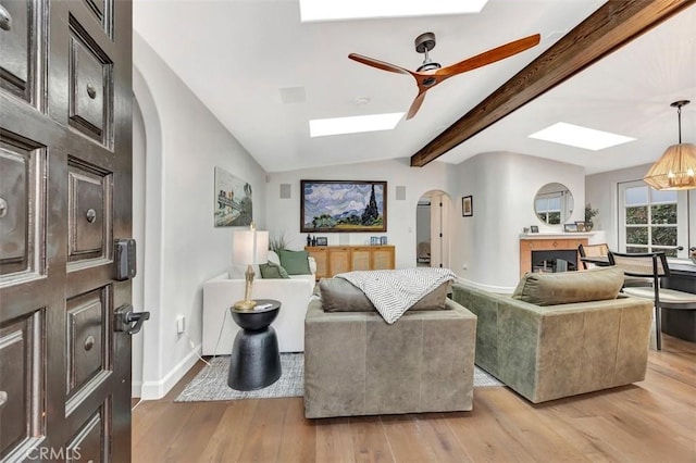 306 Avenida Monterey, San Clemente, CA 92672 - living area with a skylight, arched walkways, light wood-type flooring, ceiling fan, and baseboards