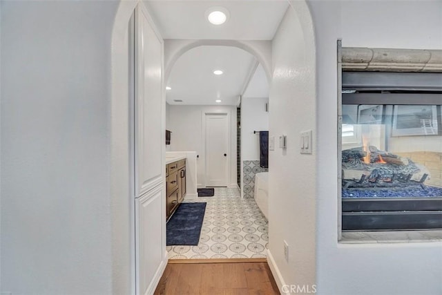 306 Avenida Monterey, San Clemente, CA 92672 - hall featuring arched walkways, wood finished floors, baseboards, and recessed lighting