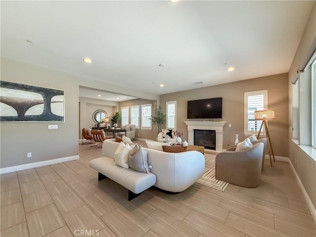 6184 Lafayette St, Chino, CA 91710 - living area with baseboards, a glass covered fireplace, plenty of natural light, and recessed lighting