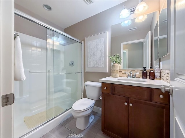 6184 Lafayette St, Chino, CA 91710 - bathroom featuring backsplash, a stall shower, toilet, vanity, and baseboards