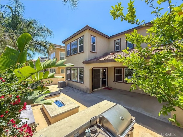 6184 Lafayette St, Chino, CA 91710 - rear view of house with stucco siding, a tiled roof, a patio area, an outdoor kitchen, and central air condition unit