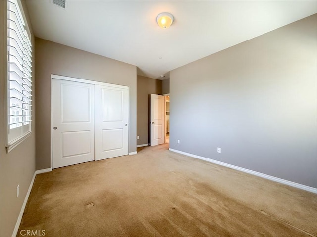 6184 Lafayette St, Chino, CA 91710 - unfurnished bedroom with light colored carpet, baseboards, and a closet