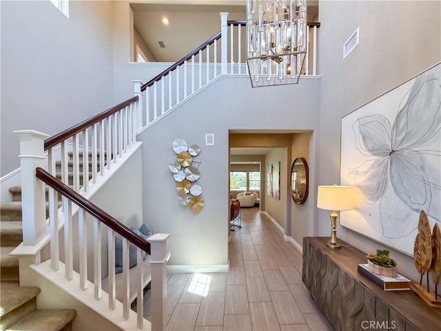 6184 Lafayette St, Chino, CA 91710 - stairway with a towering ceiling, a chandelier, and baseboards