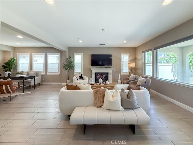 6184 Lafayette St, Chino, CA 91710 - living area featuring a glass covered fireplace, baseboards, recessed lighting, and light tile patterned flooring
