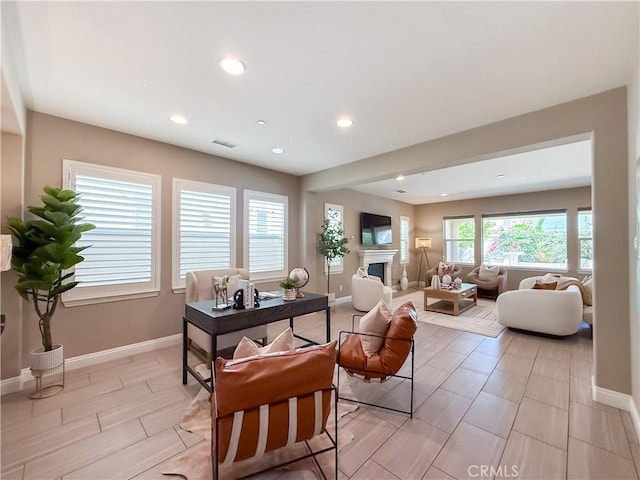 6184 Lafayette St, Chino, CA 91710 - living area with baseboards, a glass covered fireplace, and recessed lighting